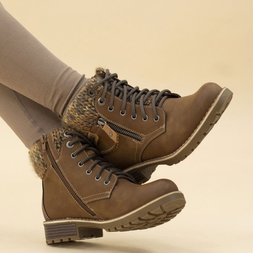 Brown ankle boots styled on model, featuring faux knit collar, zip and lace fastening, contrast stitching, and low block heel with rugged outsole for winter comfort.