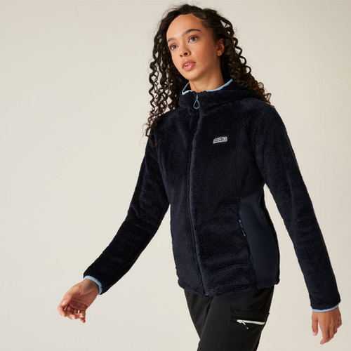 A woman wearing a navy full zip fluffy fleece.