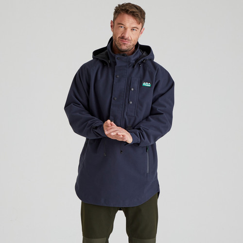 Men’s navy waterproof smock jacket worn outdoors, featuring a high collar, adjustable hood and waist drawcord.