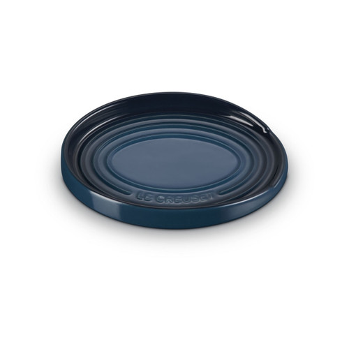 A dark blue coloured oval spoon rest.