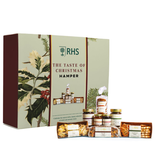A festive gift hamper labeled "The Taste of Christmas" by RHS. The box features holly designs and contains various jars and packaged treats, evoking a luxurious holiday feel.