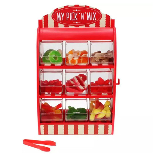 A red candy dispenser labelled "My Pick 'n' Mix" has nine compartments filled with assorted colourful gummies. Red tongs are placed in front.