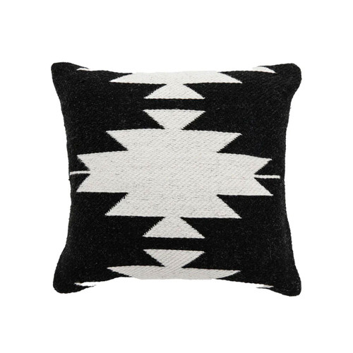 A square cushion with a bold black and white geometric pattern.