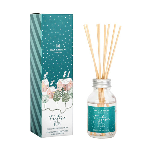 Festive Fir reed diffuser with natural wooden reeds in a clear glass bottle, shown alongside its teal and white gift box illustrated with snowy houses and fir trees. The fragrance combines pine, mistletoe, and moss.