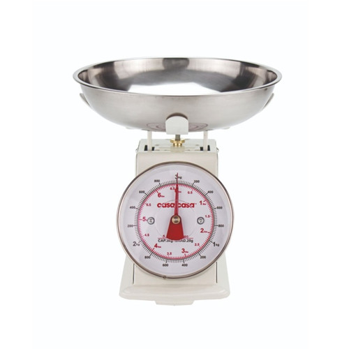A view of a traditional cream weighing scale on a white background