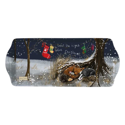Rectangular Christmas tray illustrated by Alex Clark, showing a fox, badger, and rabbit sleeping together beneath a tree in the snow. Above them hang colourful stockings on a line, with the words “’Twas the night before Christmas” written against a dark winter sky.