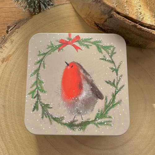 Square festive tin featuring a fluffy red-breasted robin inside a wreath of green foliage with a red bow, on a beige snowy background.