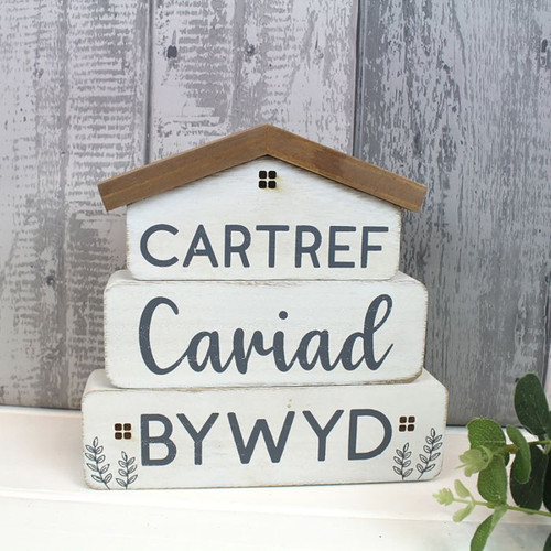 A view of a Welsh wooden decoration on a grey background