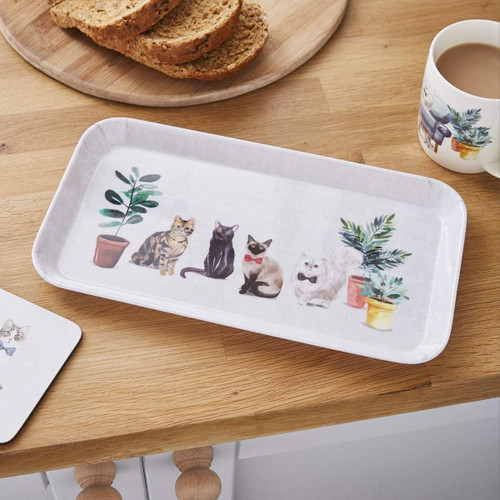 Small rectangular Curious Cats tray featuring playful cat illustrations and potted plants, displayed on a wooden kitchen counter with toast and tea.