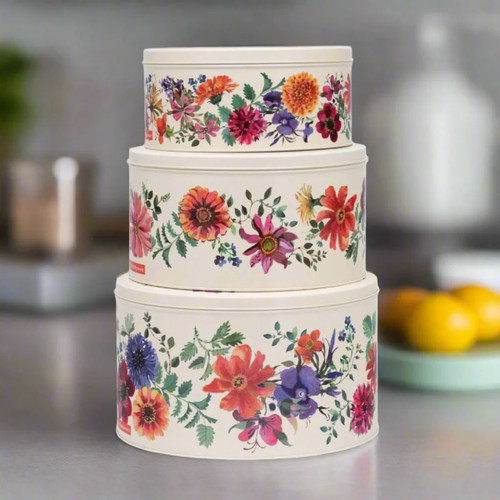 Stacked set of three Emma Bridgewater floral cake tins with colourful flower design on cream background, displayed on a kitchen counter.