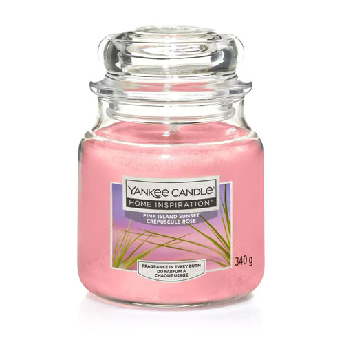 Yankee Candle Home Inspiration Pink Island Sunset 340g jar candle with pink wax and tropical-themed label in a classic glass jar.