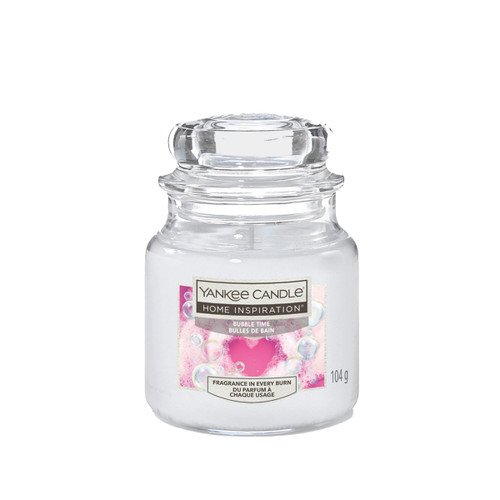 A glass jar Yankee Candle labelled "Home Inspiration, Bubble Time," in pink, with a bubbly design. The aroma suggests relaxation and freshness.