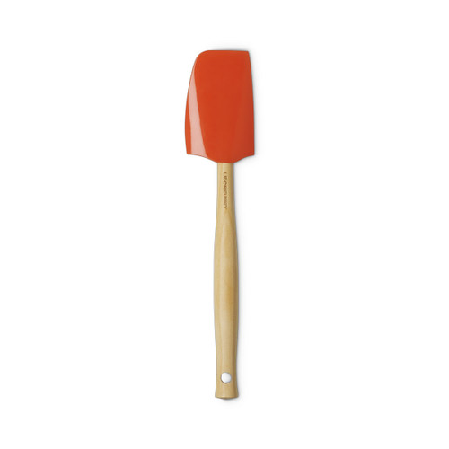Full view of the Le Creuset Medium Spatula in Volcanic, featuring an orange silicone head and smooth wooden handle with hanging hole.