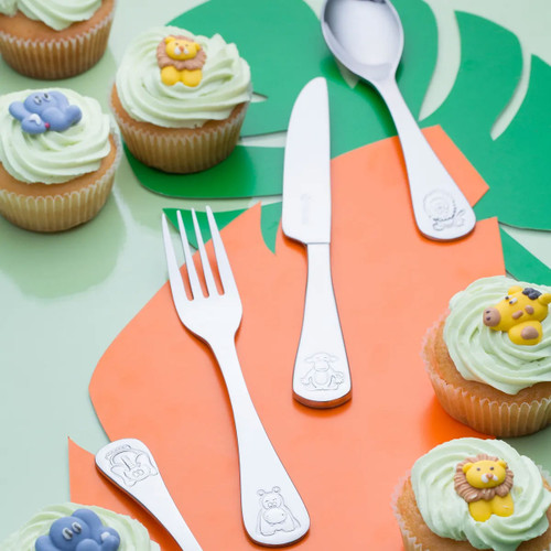 Viners Jungle 4-piece children’s cutlery set with animal-engraved handles, surrounded by decorated cupcakes on a colourful background.