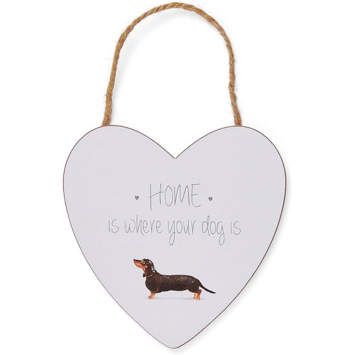 Heart-shaped hanging sign with a jute rope, featuring the phrase ‘Home is where your dog is’ and an illustration of a dachshund at the bottom.