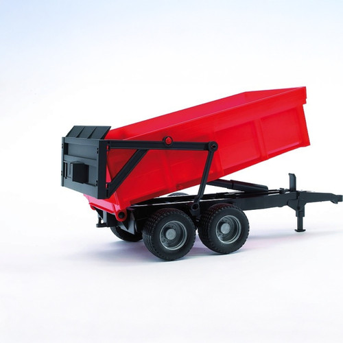 A view of a red tipper trailer toy on a white background