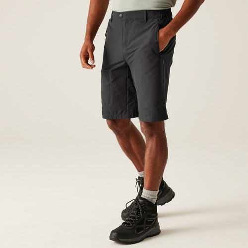 A front view of a man wearing a pair of grey Regatta walking shorts on a white background