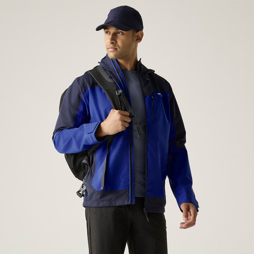 A front view of a man wearing a blue Regatta waterproof jacket on a white background