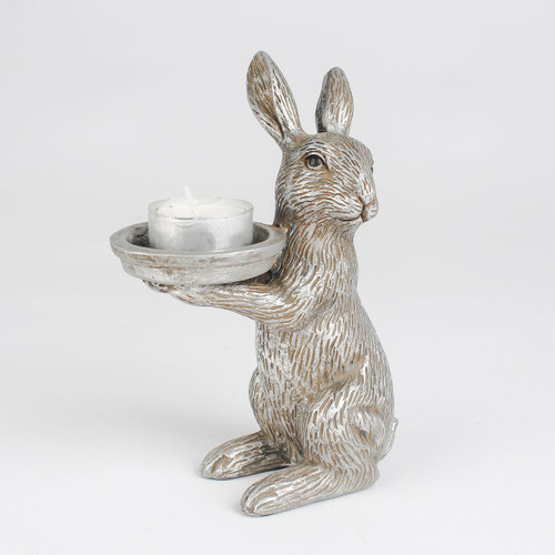 Antique-style rabbit figurine holding a candle holder with a white candle. The rabbit has a textured, weathered silver finish.