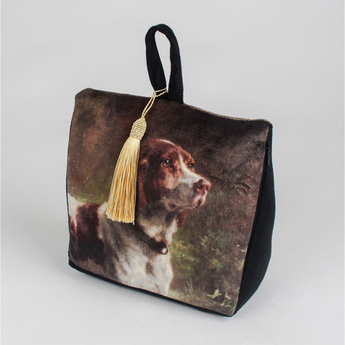 Decorative bag with a painted dog portrait on the front, featuring a golden tassel hanging from a black handle. The tone is elegant and vintage.