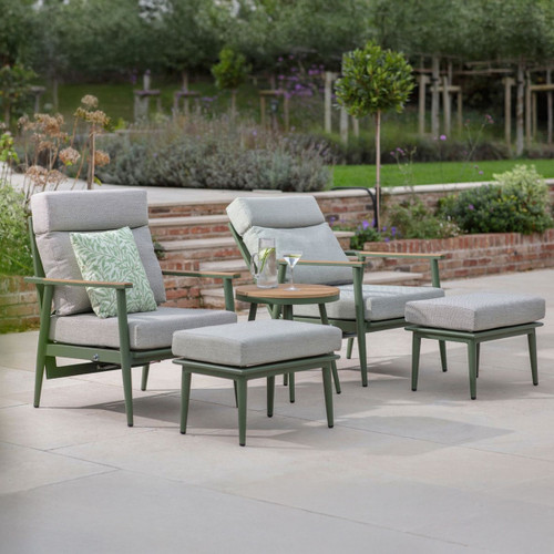 Sage green reclining garden lounge set with eco mist cushions, two armchairs and matching footstools with a round wood-effect side table on a patio.