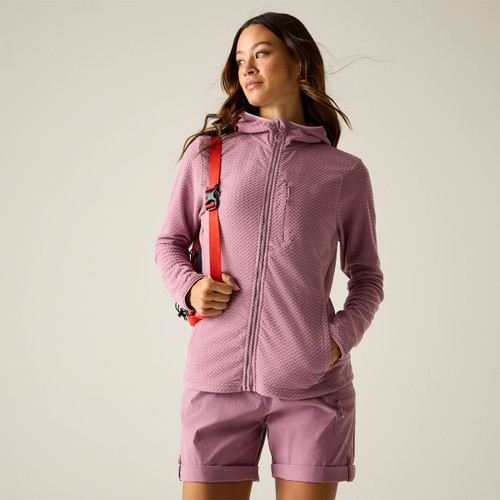 Model wearing a pink textured zip-up hooded jacket with a zipped chest pocket, styled with pink shorts and a red strap bag.