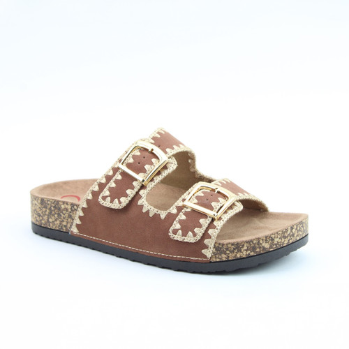 Brown slip-on sandal with a cork footbed, two gold buckle straps, and decorative cream stitching, on a white background.
