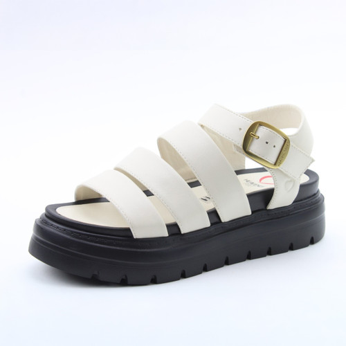 White strappy platform sandal with a gold buckle ankle strap and chunky black treaded sole on a white background.