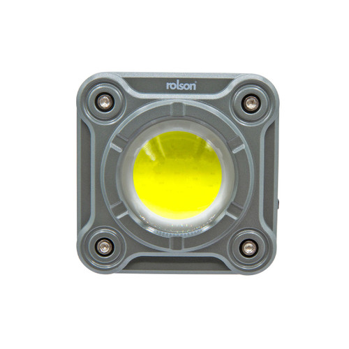 Square LED work light with a metallic grey housing, featuring a central bright yellow LED and four visible screws. The design is industrial and sturdy.