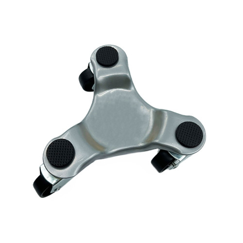 Triangular silver object with three black rubber pads and small wheels on each corner. Appears to be a furniture or appliance mover on a white background.