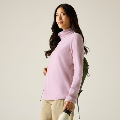 Model wearing a lilac long-sleeve half-zip fleece with a high collar, shown from the side