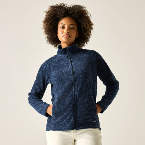 Model wearing a navy marl full-zip fleece jacket with a high collar, hands in pockets, against a light background.