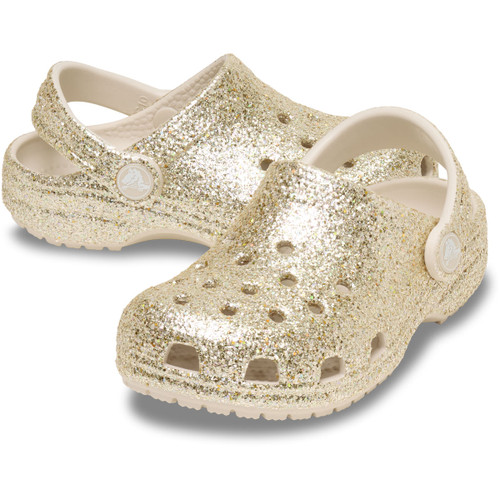 Gold glitter Crocs Children's Classic Clog with cream heel strap, shown at a three-quarter angle on a white background.