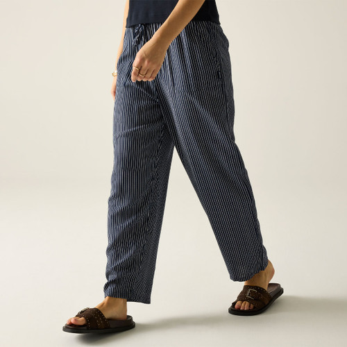 Close-up of navy pinstripe trousers worn with brown sandals.