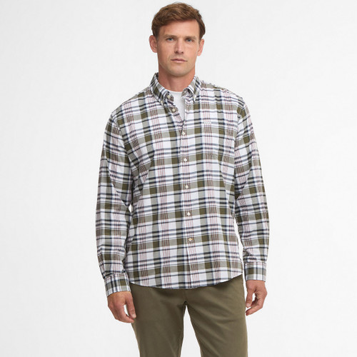 Man wearing a white and olive plaid button-up shirt with khaki pants, set against a plain white background. The expression is neutral and relaxed.
