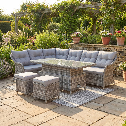Florida grey rattan rectangular corner sofa set with rising table and cushions in landscaped garden setting