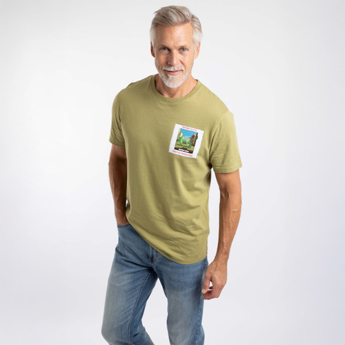 Man wearing an olive green graphic T-shirt with a small ‘Shrimp Floyd’ print on the left chest.