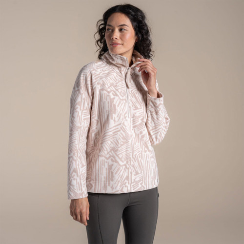 Woman wearing a pale pink patterned half-zip fleece with a high collar, shown from the front.