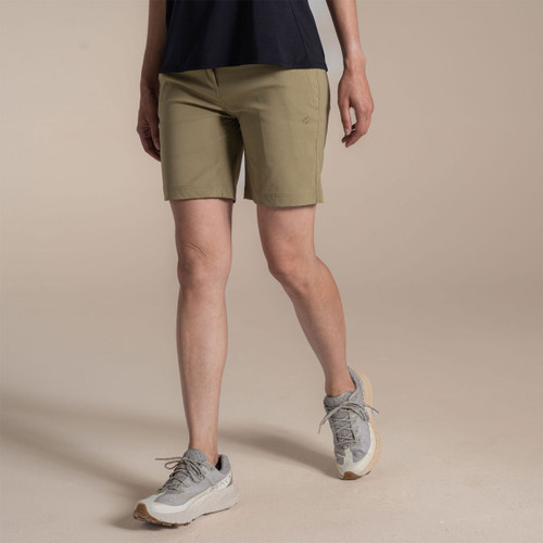 Model wearing khaki women’s walking shorts with grey trainers, side view on studio background.