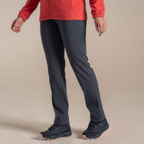 Model wearing dark grey Craghoppers walking trousers, side view, paired with red fleece jacket and hiking shoes.