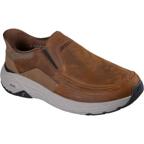Brown slip-on shoe with a leather finish, featuring detailed stitching and a thick, cushioned white Arch Fit sole. The shoe conveys comfort and durability.