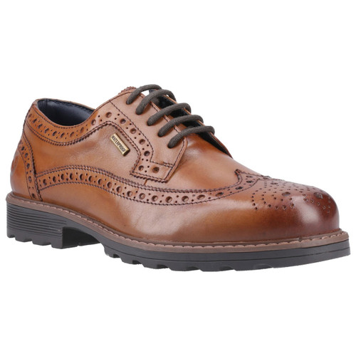 Brown leather brogue shoe with decorative perforations, black laces, and a sturdy rubber sole. A small waterproof label is attached, conveying durability.