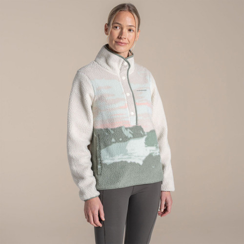 Model wearing a women’s borg fleece half-snap pullover in cream with sage green landscape print panel and high funnel neck.