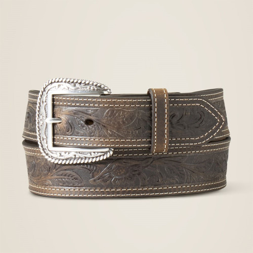 Brown tooled leather belt with floral embossing, contrast double stitching, and an ornate silver buckle, shown rolled on a light background.