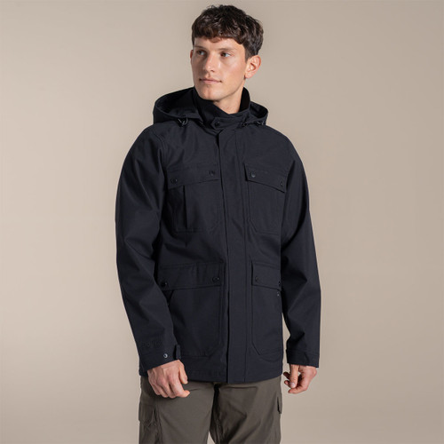 Model wearing a navy hooded jacket, front view, showing four flap pockets and popper fastenings.