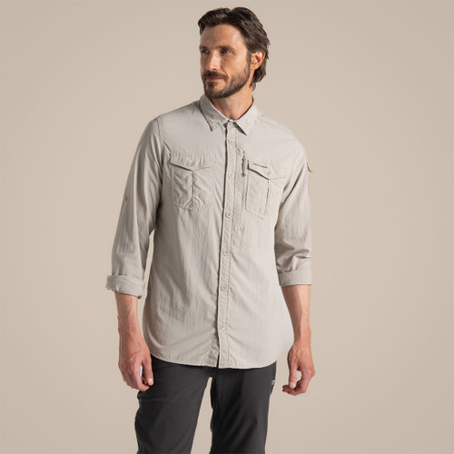 Front view of the model wearing the parchment long-sleeved adventure shirt with sleeves rolled up.