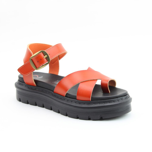 Orange leather platform sandal with crossed front straps, an ankle buckle, and a chunky black sole, on a white background.