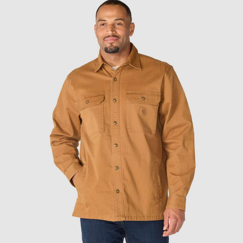 Front view of a man wearing the tan Carhartt button-up shirt jacket, showing the collar, buttons and chest pockets.