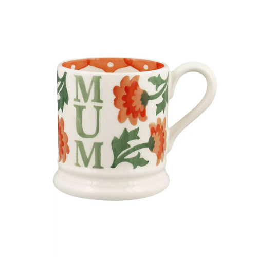 Half-pint ceramic mug with green ‘MUM’ lettering and orange chrysanthemum flowers, shown with handle on the left.
