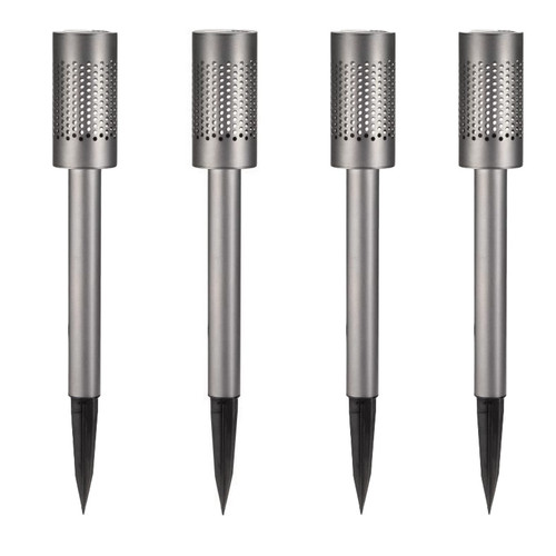4 pack of solar garden stake light at night, with a silver perforated cylinder shade casting a dotted glow onto nearby gravel and plants.